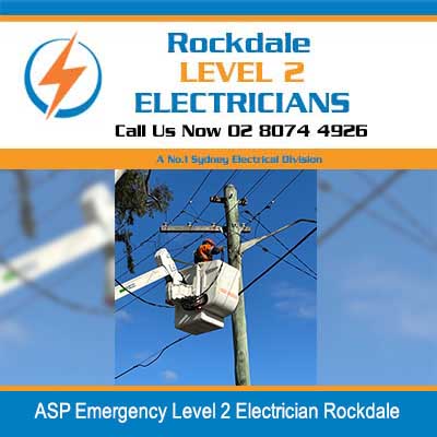 Emergency electrician in cherry picker bucket working on power pole and lines in Rockdale