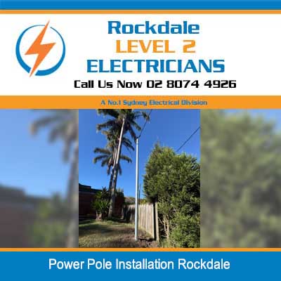 New wooden power pole installation in residential yard with trees in Rockdale
