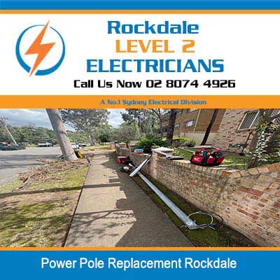 Power pole lying on ground ready for installation with excavator in Rockdale